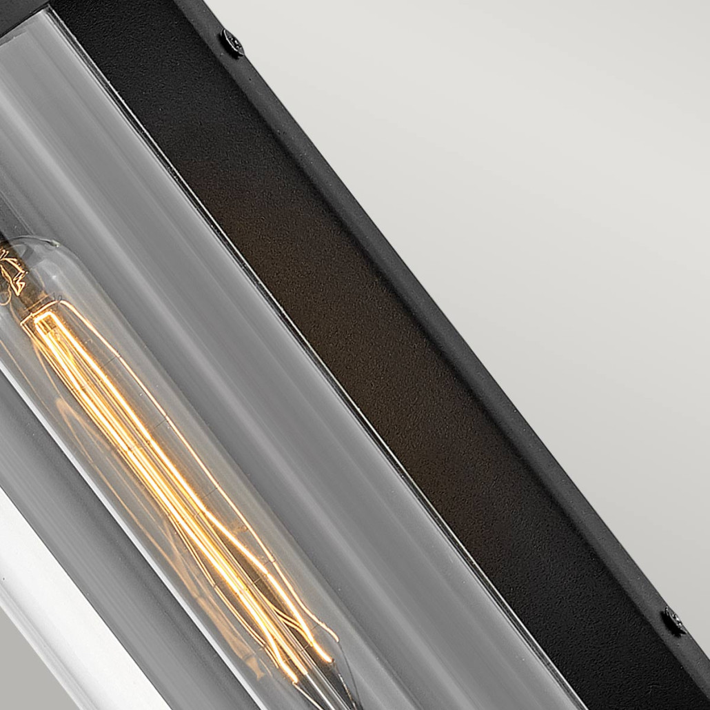 Настенный фонарь в индустриальном стиле с вытянутым цилиндрическим плафоном из прозрачного стекла и черным корпусом Hinkley